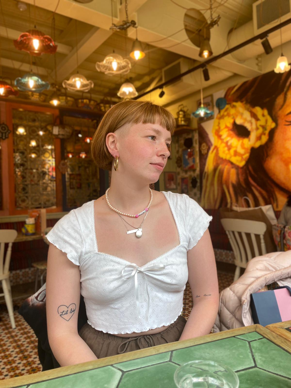 girl wearing white crop top with cap sleeves and lettuce hems
